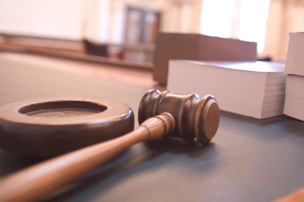 Wooden gavel resting on a courtroom desk