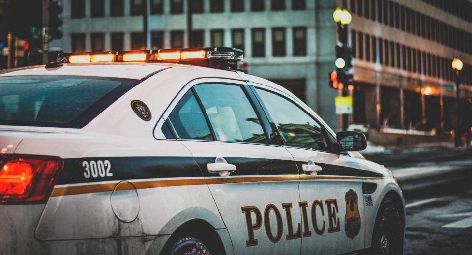 Police car parked along a city street