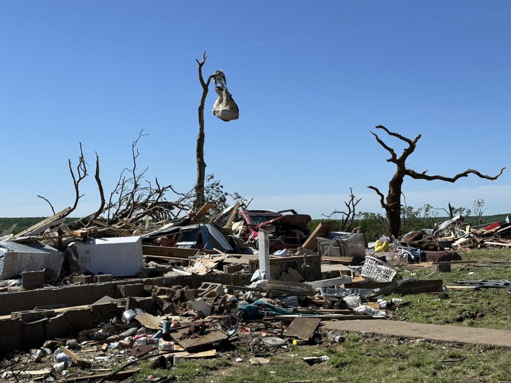 Splintered trees and house debris after a tornado